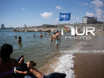 Dozens of Barcelona residents protest on the Somorrostro beach in the Barceloneta neighborhood against the America's Cup 2024, in Barcelona,...