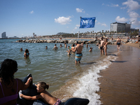 Dozens of Barcelona residents protest on the Somorrostro beach in the Barceloneta neighborhood against the America's Cup 2024, in Barcelona,...