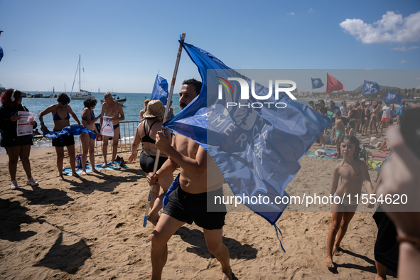 Dozens of Barcelona residents protest on the Somorrostro beach in the Barceloneta neighborhood against the America's Cup 2024, in Barcelona,...