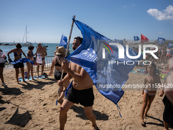 Dozens of Barcelona residents protest on the Somorrostro beach in the Barceloneta neighborhood against the America's Cup 2024, in Barcelona,...