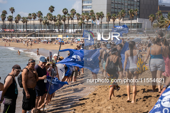 Dozens of Barcelona residents protest on the Somorrostro beach in the Barceloneta neighborhood against the America's Cup 2024, in Barcelona,...