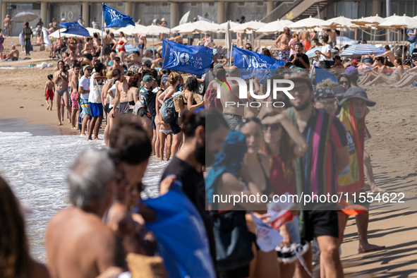 Dozens of Barcelona residents protest on the Somorrostro beach in the Barceloneta neighborhood against the America's Cup 2024, in Barcelona,...