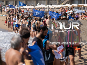 Dozens of Barcelona residents protest on the Somorrostro beach in the Barceloneta neighborhood against the America's Cup 2024, in Barcelona,...