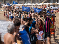 Dozens of Barcelona residents protest on the Somorrostro beach in the Barceloneta neighborhood against the America's Cup 2024, in Barcelona,...