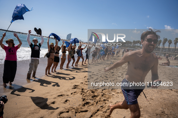 Dozens of Barcelona residents protest on the Somorrostro beach in the Barceloneta neighborhood against the America's Cup 2024, in Barcelona,...