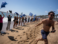 Dozens of Barcelona residents protest on the Somorrostro beach in the Barceloneta neighborhood against the America's Cup 2024, in Barcelona,...