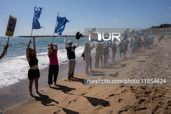 Dozens of Barcelona residents protest on the Somorrostro beach in the Barceloneta neighborhood against the America's Cup 2024, in Barcelona,...