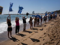 Dozens of Barcelona residents protest on the Somorrostro beach in the Barceloneta neighborhood against the America's Cup 2024, in Barcelona,...