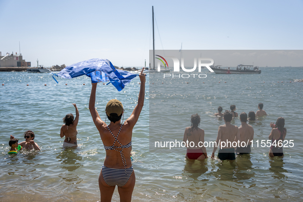 Dozens of Barcelona residents protest on the Somorrostro beach in the Barceloneta neighborhood against the America's Cup 2024, in Barcelona,...