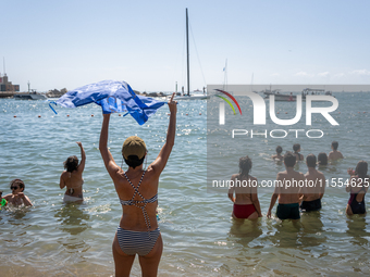 Dozens of Barcelona residents protest on the Somorrostro beach in the Barceloneta neighborhood against the America's Cup 2024, in Barcelona,...