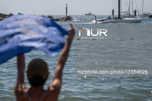 Dozens of Barcelona residents protest on the Somorrostro beach in the Barceloneta neighborhood against the America's Cup 2024, in Barcelona,...