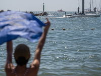 Dozens of Barcelona residents protest on the Somorrostro beach in the Barceloneta neighborhood against the America's Cup 2024, in Barcelona,...