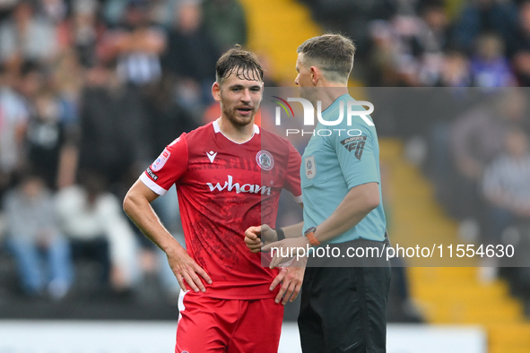 Referee Martin Woods speaks with Donald Love of Accrington Stanley during the Sky Bet League 2 match between Notts County and Accrington Sta...