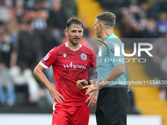 Referee Martin Woods speaks with Donald Love of Accrington Stanley during the Sky Bet League 2 match between Notts County and Accrington Sta...