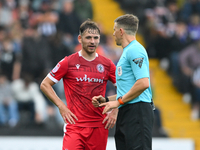 Referee Martin Woods speaks with Donald Love of Accrington Stanley during the Sky Bet League 2 match between Notts County and Accrington Sta...