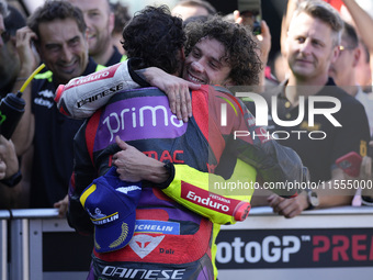 Marco Bezzecchi of Italy and Pertamina Enduro VR46 Racing Team congratulates Franco Morbidelli of Italy and Prima Pramac Racing during the q...