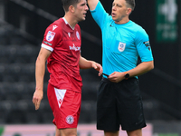 Referee Martin Woods shows a yellow card to Seb Quirk of Accrington Stanley during the Sky Bet League 2 match between Notts County and Accri...