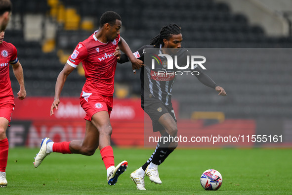 Jevani Brown of Notts County is under pressure from Zach Awe of Accrington Stanley during the Sky Bet League 2 match between Notts County an...