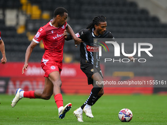 Jevani Brown of Notts County is under pressure from Zach Awe of Accrington Stanley during the Sky Bet League 2 match between Notts County an...