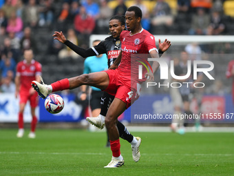 Jevani Brown of Notts County puts pressure on Zach Awe of Accrington Stanley during the Sky Bet League 2 match between Notts County and Accr...