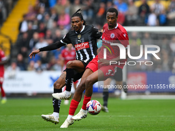 Jevani Brown of Notts County puts pressure on Zach Awe of Accrington Stanley during the Sky Bet League 2 match between Notts County and Accr...