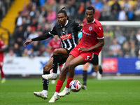 Jevani Brown of Notts County puts pressure on Zach Awe of Accrington Stanley during the Sky Bet League 2 match between Notts County and Accr...