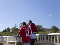 People walk near the Benfica ''Estadio da Luz'' in Lisbon, Portugal, on September 7, 2024. The soccer team has a new coach, Portuguese exper...