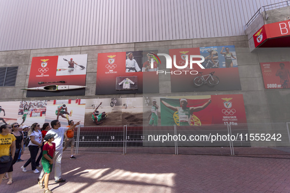 People walk by pictures of Olympians at the Benfica ''Estadio da Luz'' in Lisbon, Portugal, on September 7, 2024. The soccer team has a new...