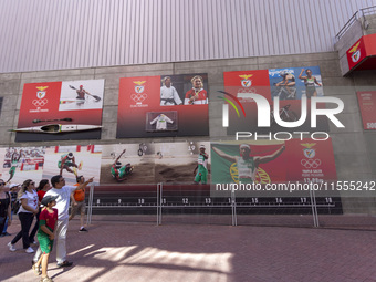 People walk by pictures of Olympians at the Benfica ''Estadio da Luz'' in Lisbon, Portugal, on September 7, 2024. The soccer team has a new...