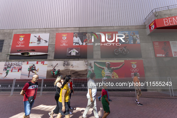 People walk by pictures of Olympians at the Benfica ''Estadio da Luz'' in Lisbon, Portugal, on September 7, 2024. The soccer team has a new...