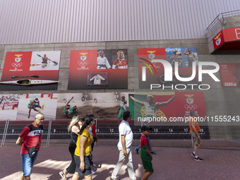 People walk by pictures of Olympians at the Benfica ''Estadio da Luz'' in Lisbon, Portugal, on September 7, 2024. The soccer team has a new...