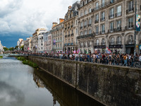 People march holding a banner that reads, 'A single solution destitution', during a protest after the appointment of a right-wing prime mini...