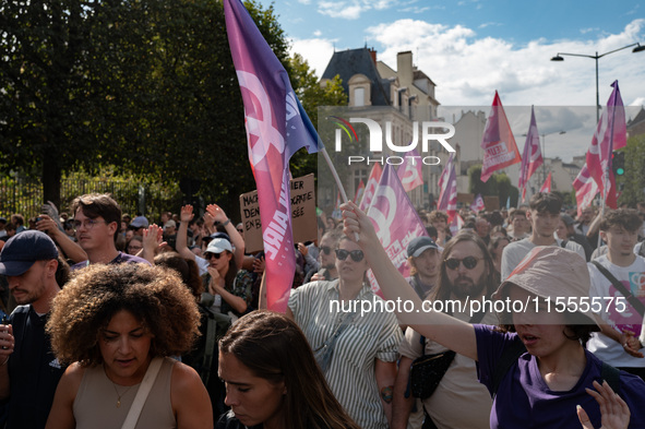 People march holding a banner that reads, 'A single solution destitution', during a protest after the appointment of a right-wing prime mini...