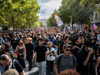 People march holding a banner that reads, 'A single solution destitution', during a protest after the appointment of a right-wing prime mini...