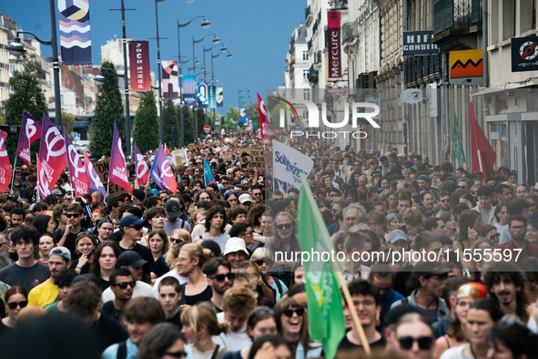 People march holding a banner that reads, 'A single solution destitution', during a protest after the appointment of a right-wing prime mini...