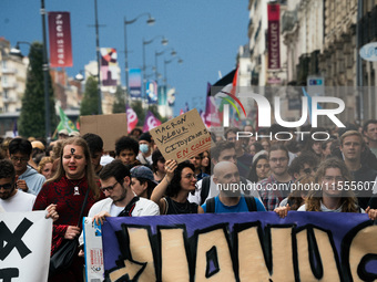 People march holding a banner that reads, 'A single solution destitution', during a protest after the appointment of a right-wing prime mini...