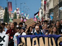 People march holding a banner that reads, 'A single solution destitution', during a protest after the appointment of a right-wing prime mini...