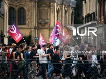 People march holding a banner that reads, 'A single solution destitution', during a protest after the appointment of a right-wing prime mini...