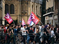 People march holding a banner that reads, 'A single solution destitution', during a protest after the appointment of a right-wing prime mini...