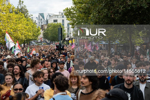 People march holding a banner that reads, 'A single solution destitution', during a protest after the appointment of a right-wing prime mini...