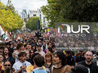 People march holding a banner that reads, 'A single solution destitution', during a protest after the appointment of a right-wing prime mini...