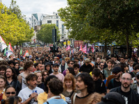 People march holding a banner that reads, 'A single solution destitution', during a protest after the appointment of a right-wing prime mini...