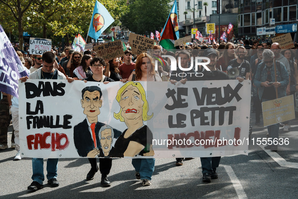 People march holding a banner that reads, 'dans la famille facho, je veux le petit Michel', during a protest after the appointment two days...