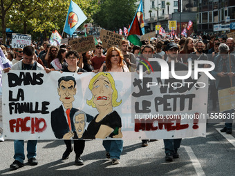 People march holding a banner that reads, 'dans la famille facho, je veux le petit Michel', during a protest after the appointment two days...