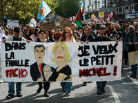 People march holding a banner that reads, 'dans la famille facho, je veux le petit Michel', during a protest after the appointment two days...