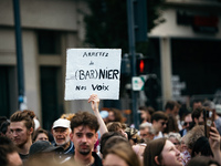 A protestor holds a placard reading, 'arretez de Barnier nos voix' as he takes part in a demonstration after the appointment of a right-wing...