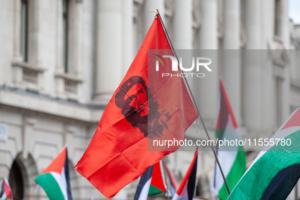 Pro-Palestinian activists and supporters wave a Palestinian flag featuring an image of Che Guevara as they march through London, United King...