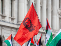 Pro-Palestinian activists and supporters wave a Palestinian flag featuring an image of Che Guevara as they march through London, United King...