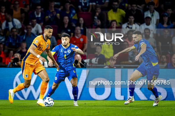 Netherlands forward Cody Gakpo and Bosnia and Herzegovina defender Jusuf Gazibegovic during the match between the Netherlands and Bosnia and...