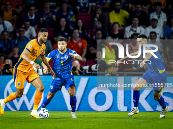 Netherlands forward Cody Gakpo and Bosnia and Herzegovina defender Jusuf Gazibegovic during the match between the Netherlands and Bosnia and...